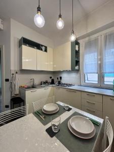 a kitchen with a table with two plates on it at Casa Angiolina in Chiavari