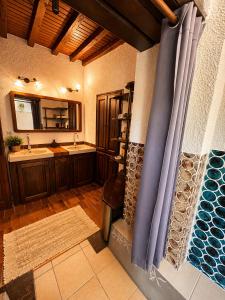 a bathroom with a sink and a shower in it at La chambre la Tricherie in Crastes