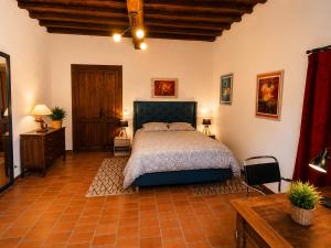 a bedroom with a large bed in a room at La chambre la Tricherie in Crastes +25 photos