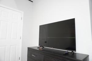 a flat screen tv sitting on top of a dresser at New York view 39 in West New York
