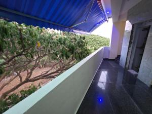a walkway in a building with a garden at Tree Top Residency in Mysore +16 photos