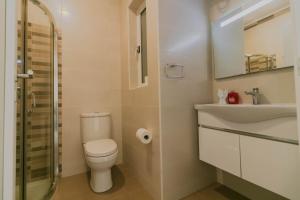 a bathroom with a toilet and a sink at Sea Steps 3 Marsalforn in Marsalforn +19 photos