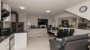 a kitchen and living room with a couch and a table at Villa Ivandvor in Split by Villas Guide in Radošić
