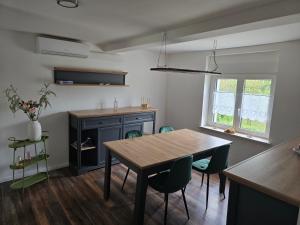 a dining room with a wooden table and chairs at Naturparadies an der Saale in Könnern
