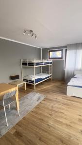 a room with two bunk beds and a desk at Jugendgästehaus Lichterfelde JuLi in Berlin