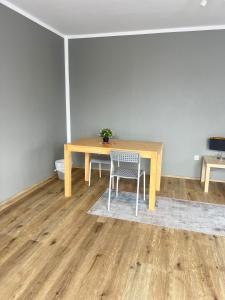 a wooden table with a chair in a room at Jugendgästehaus Lichterfelde JuLi in Berlin