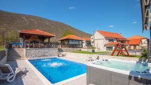 a house with a swimming pool and a house at Villa Ivandvor in Split by Villas Guide in Radošić