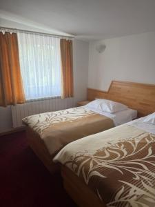 a hotel room with two beds and a window at Hotel Finida in Obrov +2 photos