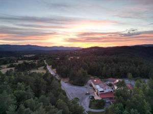 an aerial view of a building in the mountains with a sunset at Hotel Finida in Obrov