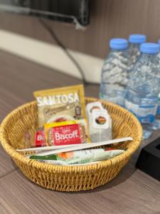 a basket with toiletries and bottles of water on a table at شقق طلال الفندقية- Talal hotel apartments in Al-ʿUla