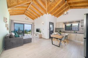 a kitchen and living room with a wooden ceiling at Vista Blu Villas in Vlachata