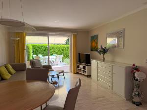 a living room with a couch and a table at Residenza delle Fonti by HolAp SA in Minusio