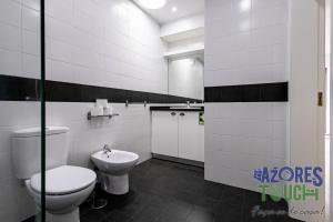 a bathroom with a toilet and a sink at Casa da Misericordia in Praia da Vitória +5 photos