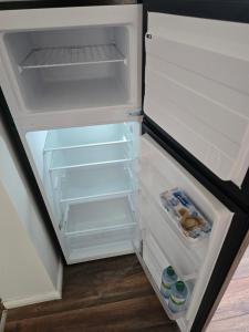 an open refrigerator with its door open and drinks inside at Naturparadies an der Saale in Könnern