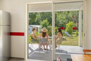 a group of people sitting at a table outside at Villa Santa Mara Poggio in Santa-Maria-Poggio +37 photos