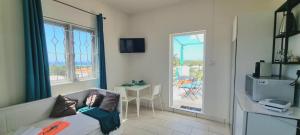 a room with a bed and a view of a patio at Abiki Mauritius with Tourism Authority Permit in Albion