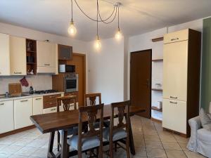 a kitchen with a wooden table and chairs in it at Lake Como - Casa Mafy in Bellano