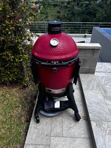 a red grill sitting on top of a sidewalk at Luxury Villa in Calabria in Gasponi