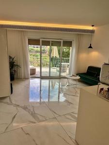 a living room with marble flooring and glass doors at S'O Suites Tropea in Tropea