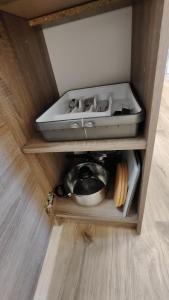 a cabinet with a pot and a pan on top of it at Apartmán pro 4 osoby, Most M1 in Most