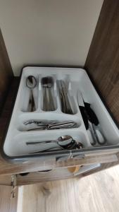 a tray of silver utensils sitting on a table at Apartmán pro 4 osoby, Most M1 in Most +14 photos