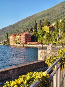 a view of a town with a river and buildings at Lake Como - Casa Mafy in Bellano