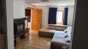 a living room with a couch and a fireplace at Haus in Roth an der Our in Roth
