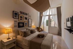 a bedroom with a large bed and a window at Sea Steps Marsalforn in Marsalforn