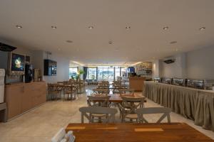 a restaurant with tables and chairs and a bar at FIFTY5 Suite Hotel in Marmaris