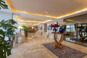 a lobby with chairs and a table with flowers on it at FIFTY5 Suite Hotel in Marmaris +18 photos