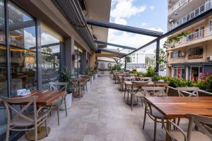 an empty restaurant with wooden tables and chairs at FIFTY5 Suite Hotel in Marmaris