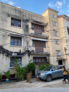 a car parked in front of a building at B4 Apartment Stone Town in Zanzibar City