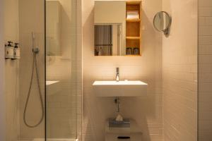 a bathroom with a sink and a shower at 9Hotel Central in Brussels +50 photos