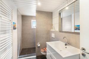 a bathroom with a sink and a mirror at Ferienwohnung Koje 1 in Wangerland +30 photos