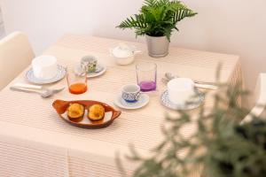 a table with a plate of food and cups on it at L'Angolo Del Teatro in Galatone +13 photos