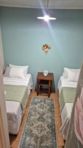 a room with two beds and a table in it at Herberg 1 in De Wildt