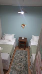 a room with two beds and a table at Herberg 1 in De Wildt +5 photos