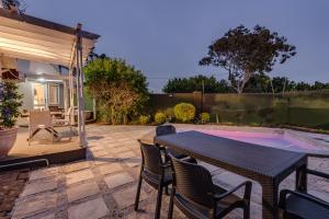 a patio with a table and chairs and a swimming pool at Mill Park Executive Suite in Hallack Rock