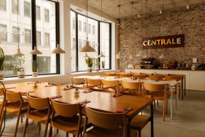 a dining room with wooden tables and chairs at 9Hotel Central in Brussels
