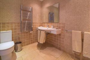 a bathroom with a white toilet and a sink at Villa Calma by Mallorca Infinity in Santa Ponsa +12 photos