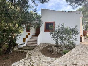 a white house with stairs and a window at Villa Calma by Mallorca Infinity in Santa Ponsa