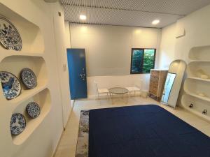 a room with blue and white plates on the wall at Kiki Cottage in Mount Ābu