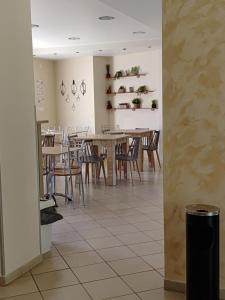 a dining room with wooden tables and chairs at Hotel Isidora in Loutrós