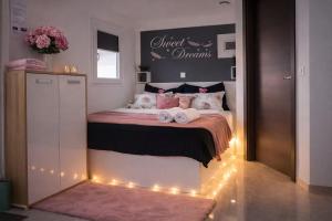 a bedroom with a bed with lights on it at Aura Luxury Suites Bled in Bled