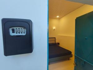 a room with a pay phone on the wall at Kiki Cottage in Mount Ābu