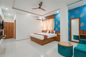 a bedroom with a bed and a couch at Hotel Vihara Inn in Bangalore