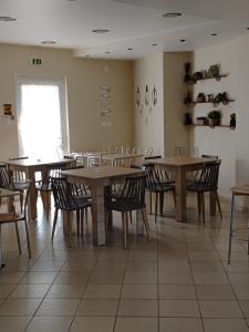 a dining room with wooden tables and chairs at Hotel Isidora in Loutrós