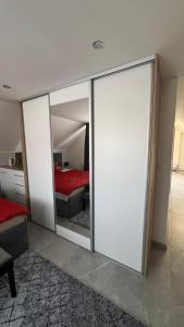 a room with mirrored walls and a bedroom with a bed at Apartmán Noel in Soľ