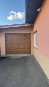 a garage door on the side of a house at Apartmán Noel in Soľ