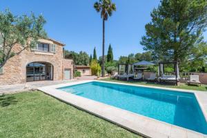 a swimming pool in the yard of a house at Agroturismo Son Bauzanet in Palma de Mallorca